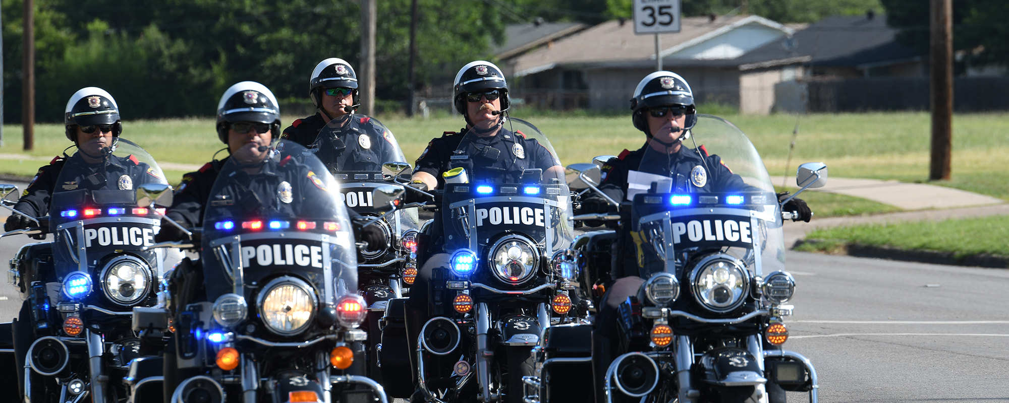 Grand Prairie color guard police officers carrying flags and rifles